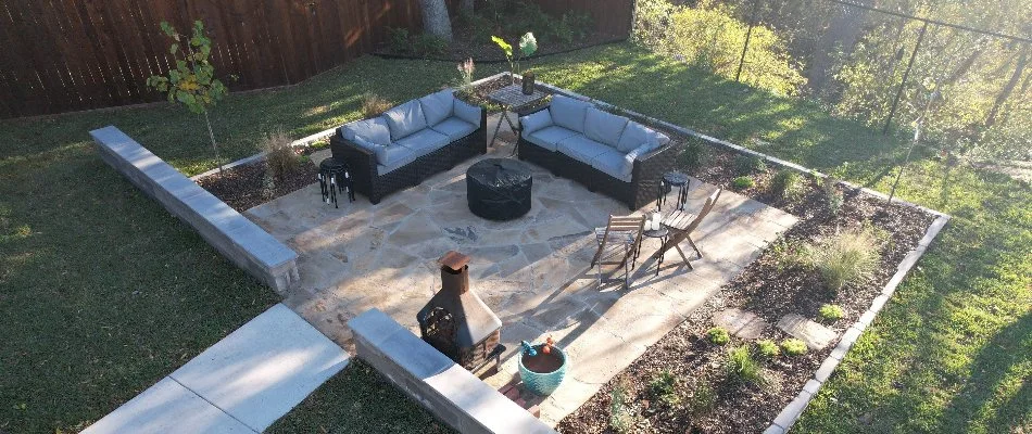 Patio in Joshua, TX, with furniture and seating walls.