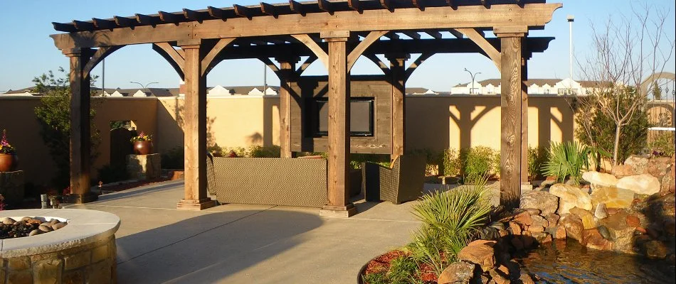 Pergola in Decatur, TX, near a fire pit and a water feature.